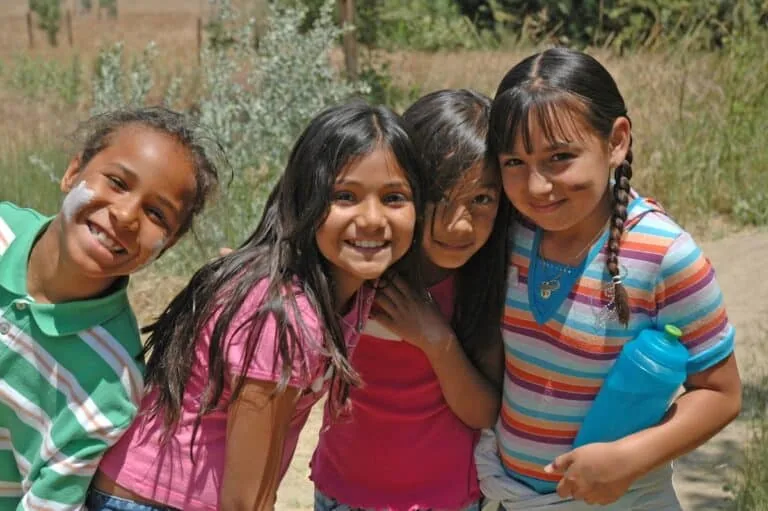 Group of diverse children smiling outdoors at Wind Wolves Preserve.
