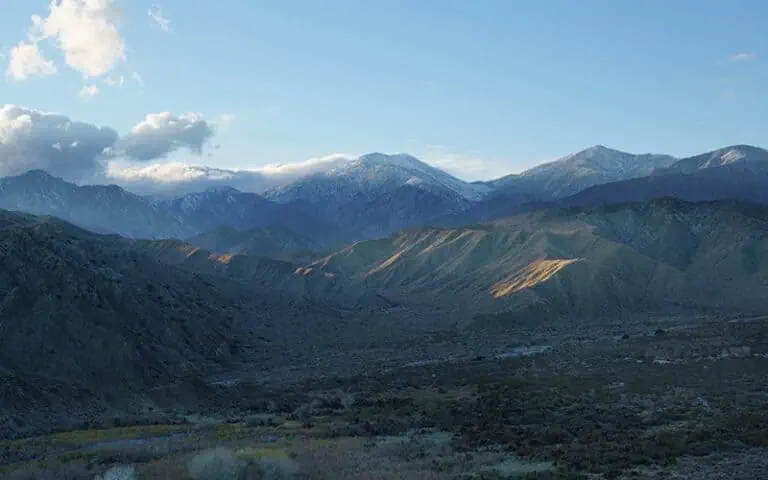 Majestic mountain range with snow-capped peaks and lush valleys.