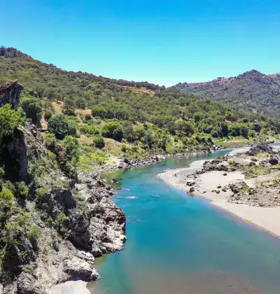 Beautiful river flowing through lush green landscape at The Wildlands Conservancy.