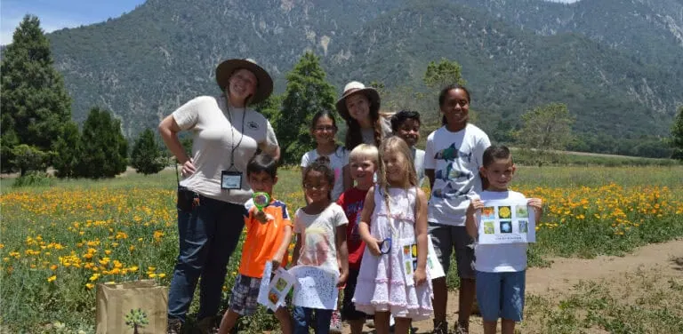 Group of children and adults enjoying outdoor activities at Wildlands Conservancy.