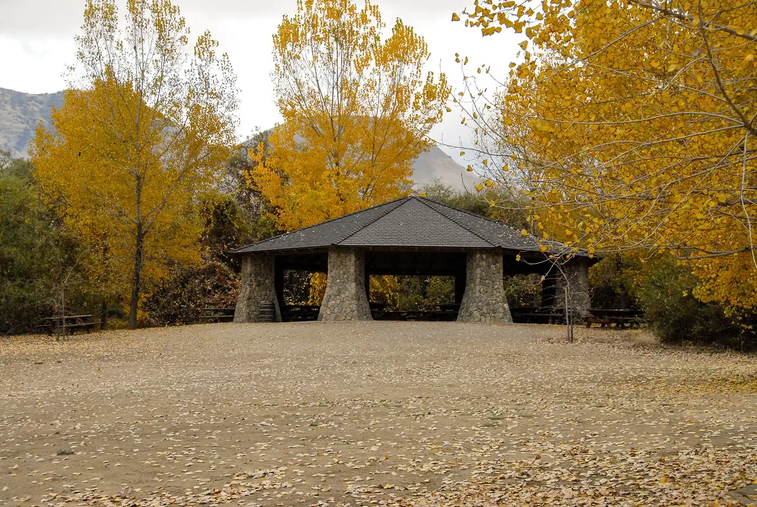 Autumn scene at The Wildlands Conservancy with a pavilion surrounded by colorful fall trees.
