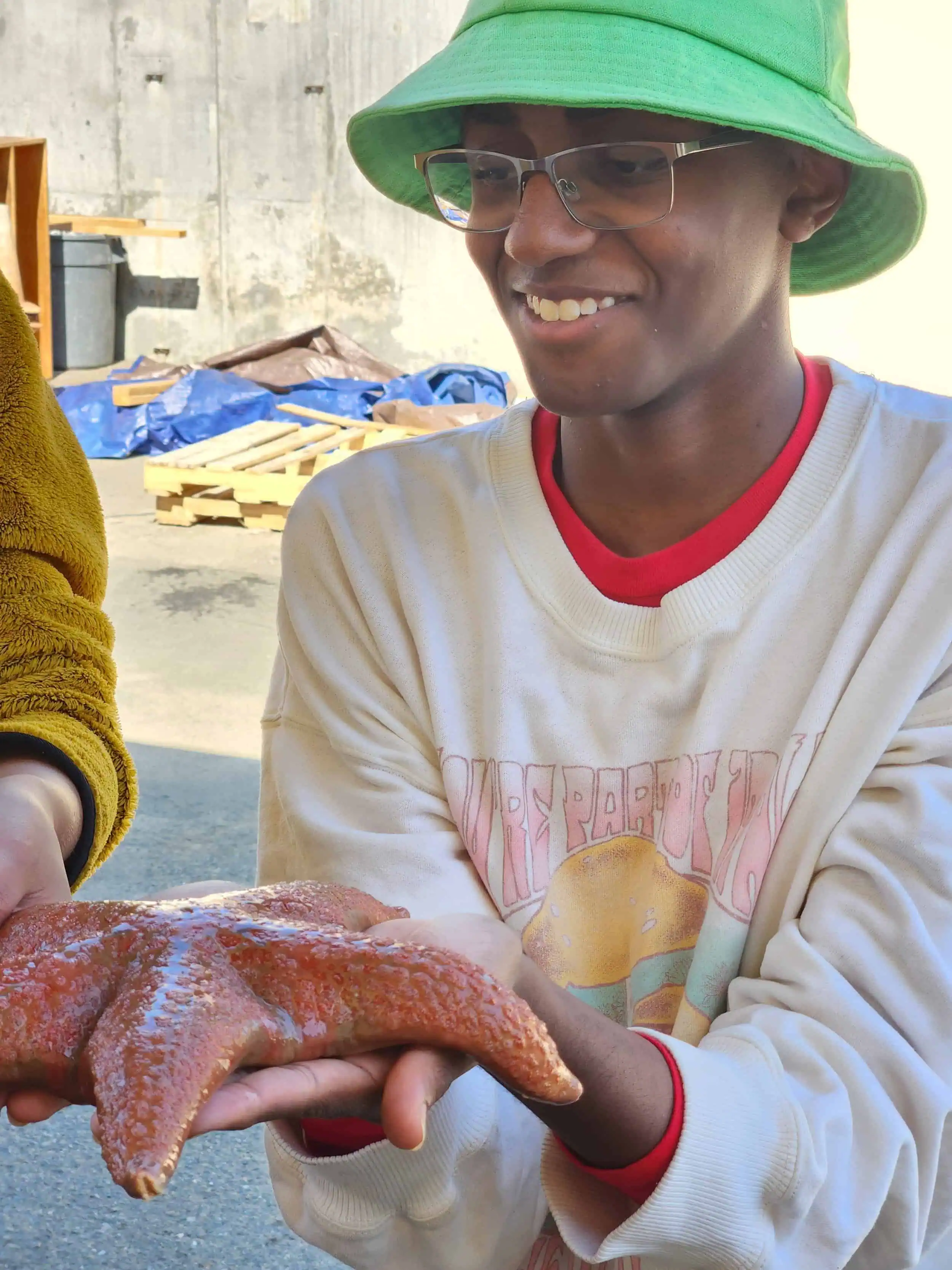 Volunteer holding a live octopus at Wildlands Conservancy event.