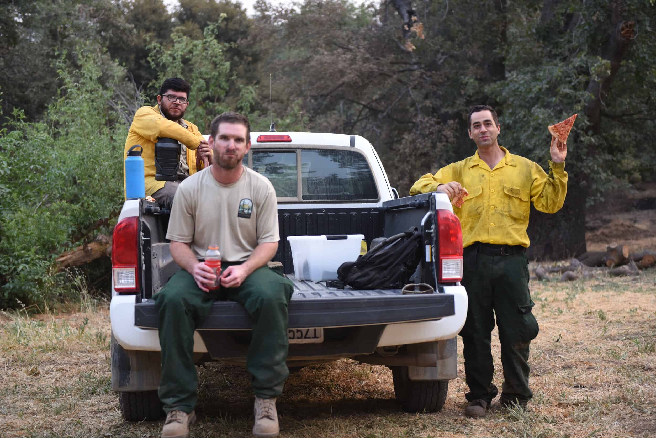 Volunteers at Wildlands Conservancy in nature, holding supplies and tools.
