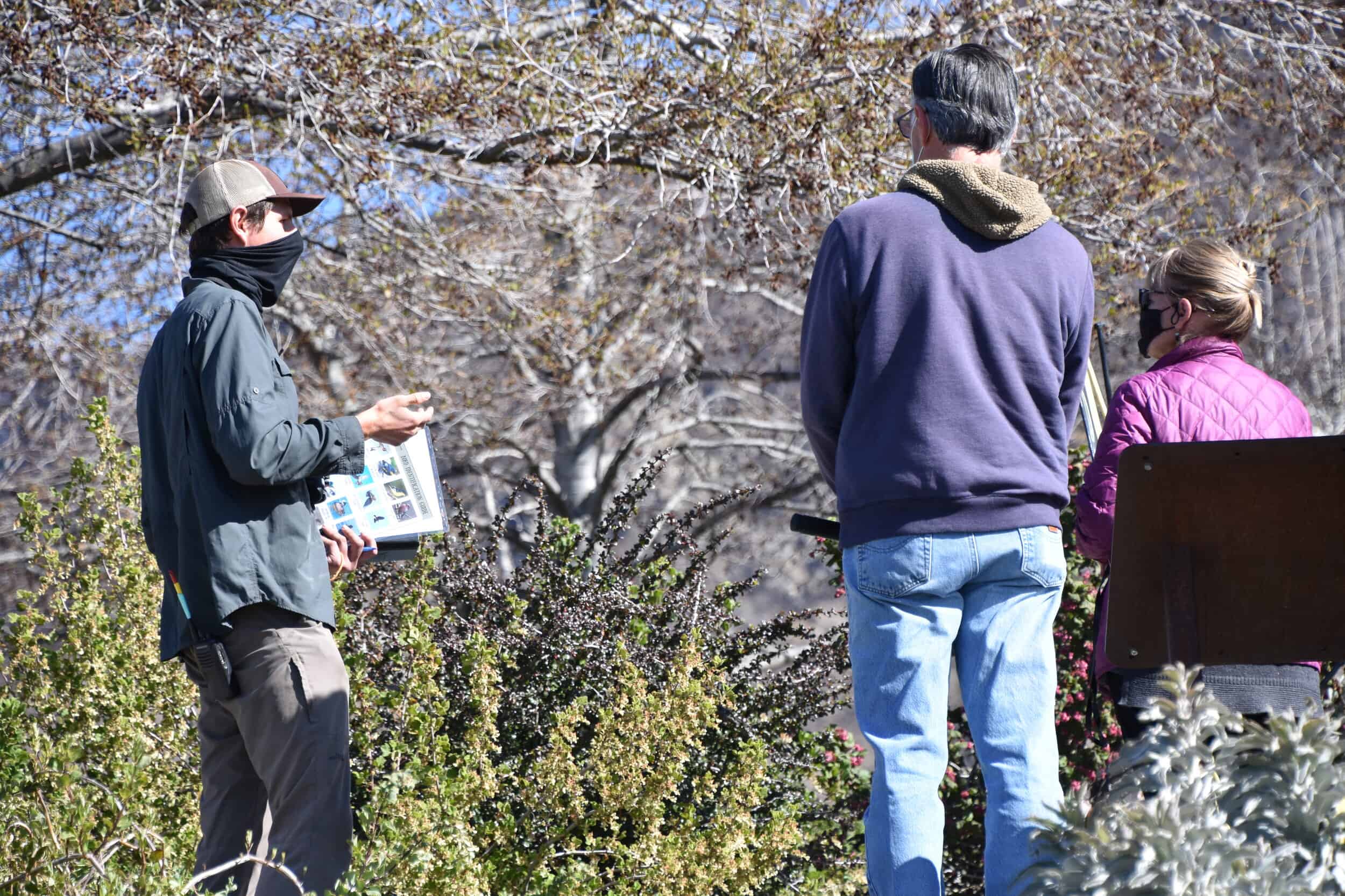 Wildlands Conservancy bird walk featuring a guide and participants observing nature.