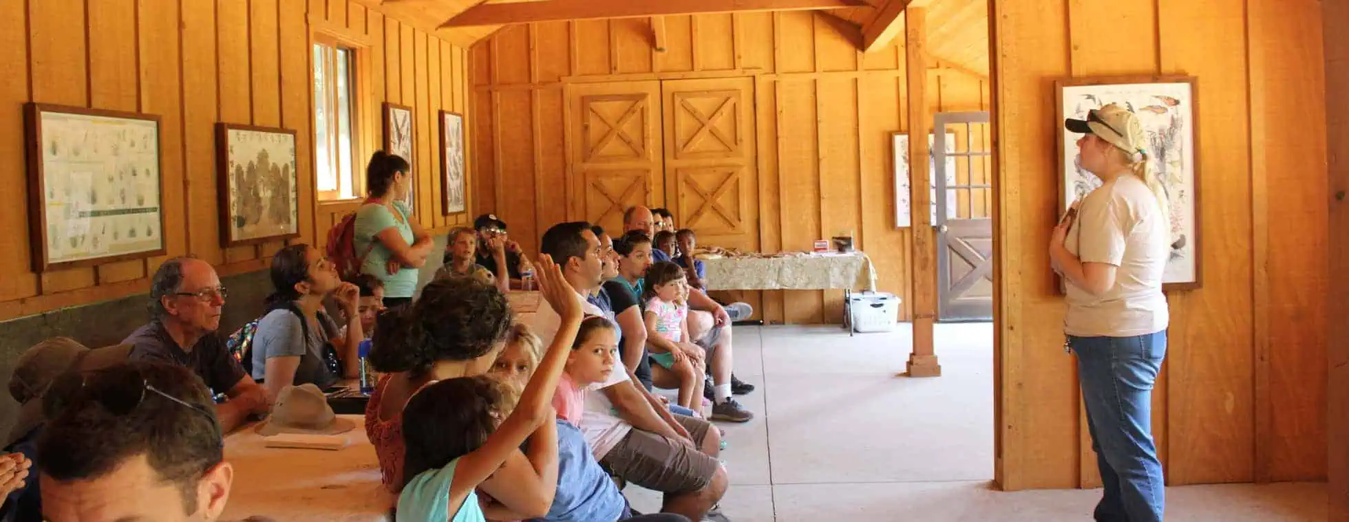Group of children and adults attending a naturalist talk at Wildlands Conservancy.