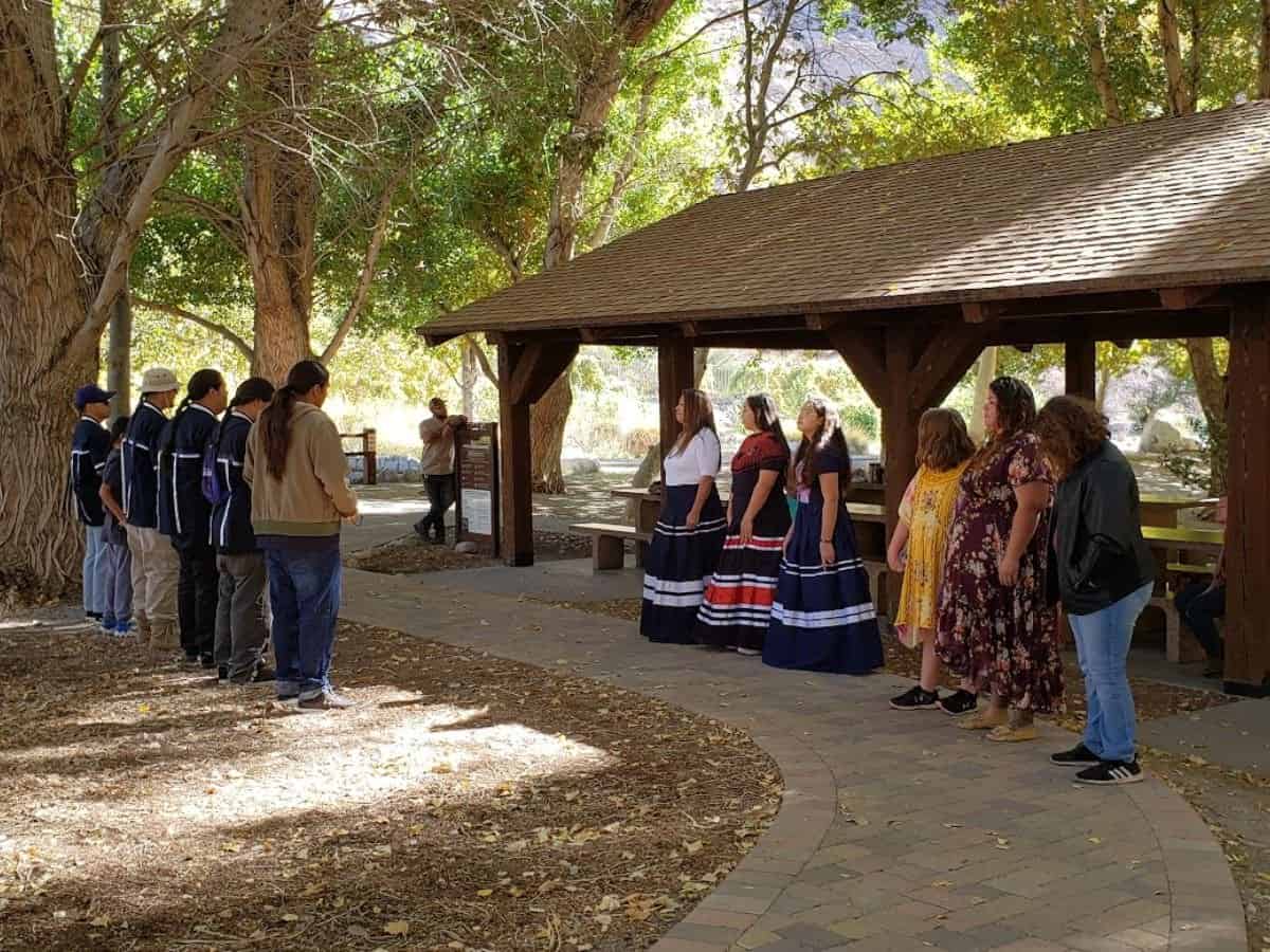 Group of people participating in a Native American Heritage Month event outdoors.