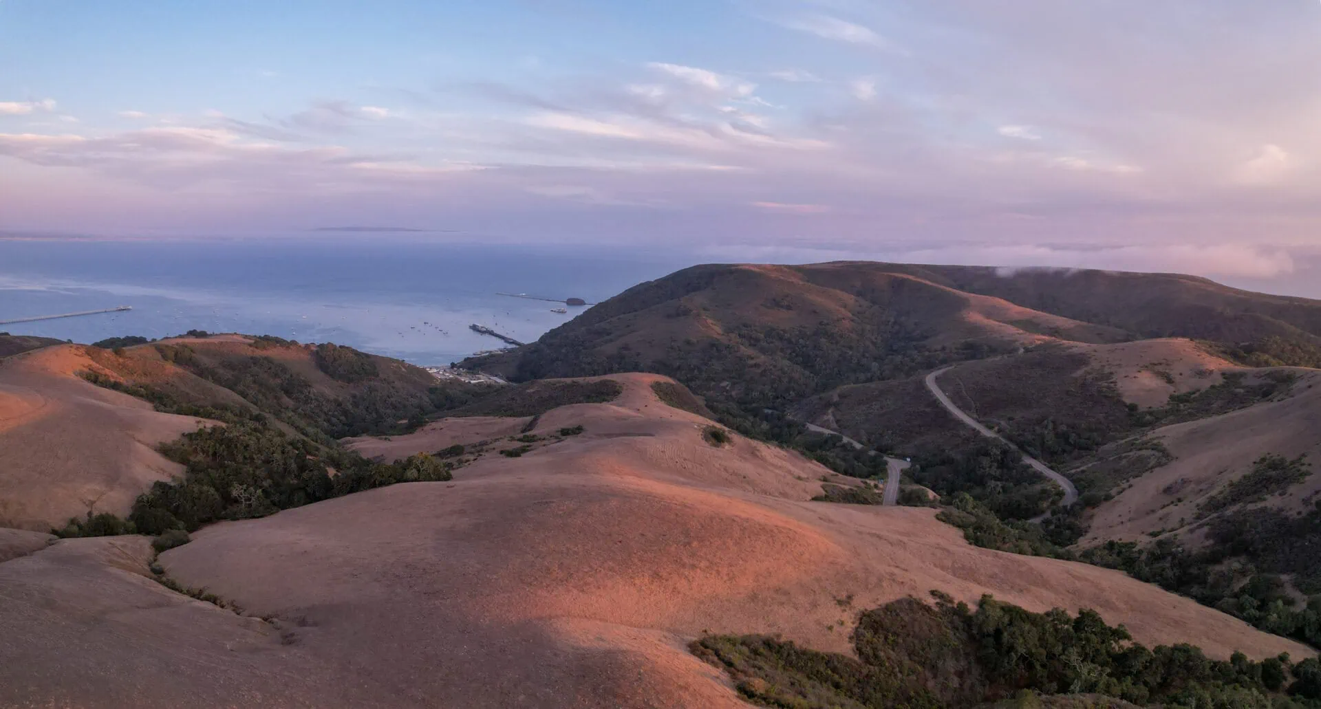 Scenic view of rolling hills and coastline at sunset in Wild Cherry Canyon.